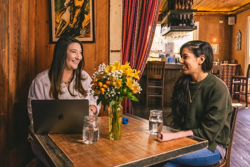 Nicole Moss interviewing a small business owner 