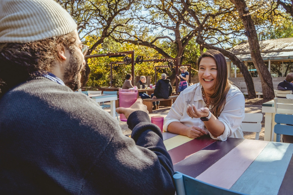 Nicole Moss speaking with an HR client over lunch